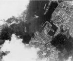 Aerial view of Kiel, Germany, Feb-Jun 1942, photo 2 of 2; note arrow in center marking position of battleship Scharnhorst; photograph probably taken by RAF personnel