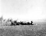 Shoho burning during Battle of Coral Sea, photographed by a torpedo bomber pilot from Yorktown, 7 May 1942; note the faint outline of a TBD-1 in bottom half of photo