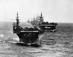 US Navy Task Group 38.3 entering Ulithi anchorage in a column following strikes in Philippine Islands, 24 Dec 1944, photo 2 of 7