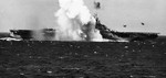 A Japanese special attack A6M aircraft crashing close aboard the starboard side of the carrier Ticonderoga off the Philippines, 5 Nov 1944. Photo 3 of 3.