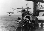 Tuscaloosa hoisting a SOC Seagull floatplane from the sea, while en route to Iceland, Sep 1941; note another SOC aircraft on starboard catapult