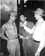 Japanese-American member of US 442nd Regimental Combat Team being interviewed aboard Victory Ship SS Waterbury Victory upon its arrival in Honolulu, US Territory of Hawaii, 9 Aug 1946