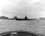 USS Wahoo departing Mare Island Naval Shipyard, Vallejo, California, United States, 10 Aug 1942; note munitions ship USS Shasta at the pier and barrage balloons overhead.