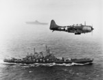 SBD-5 Dauntless aircraft flying over USS Washington and USS Lexington in the Pacific Ocean en route toward the Gilbert Islands, 12 Nov 1943