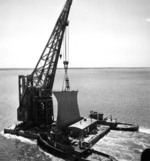 The bow of USS Kentucky being transported on a crane en route between Newport News to Norfolk, Virginia, United States, to be fitted on USS Wisconsin, circa May-Jun 1956
