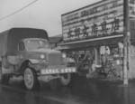 US military mail truck in front of a stationary store in Tokyo, Japan, 1951