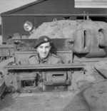 Trooper Bill Jones of the British Royal Tank Regiment in the driving seat of a Covenanter tank in Britain, 16 Feb 1942