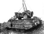A Jeep being lowered into a DUKW on Tinian, Mariana Islands, 1945