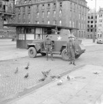 The crew of a Humber Light Reconnaissance Car Mk III feeding pigeons in Hamburg, Germany, 4 May 1945