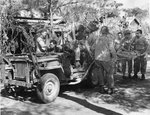 Willys Slat Grille Jeep modified into a litter carrier in Saipan, Mariana Islands, 1945; note extended exhaust pipe for stream fording