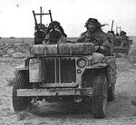 A close-up of a British heavily armed patrol of L Detachment SAS in their jeeps, just back from a three month patrol, 18 Jan 1943; note twin-mounted Vickers K machine guns; photo 3 of 3