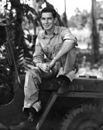 USAAF photographer Jack Heyn sitting atop a jeep, 1943
