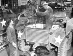 Servicing the engine of a M8 armored car, date unknown