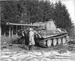 US Army officer standing next an abandoned German Panzer V Panther tank, 1944-1945