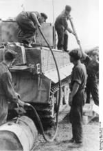 German crew replenishing fuel and ammunition for a Tiger I heavy tank on the Russian Front, Aug 1944, photo 1 of 2