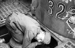 German tanker performing maintenance on a Tiger I heavy tank, near Kursk, Russia, summer 1943, photo 1 of 2