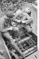 German tanker performing maintenance on a Tiger I heavy tank, near Kursk, Russia, summer 1943, photo 2 of 2
