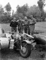 Polish resistance fighters Aleksander Wolski, Olsza, Jan Dabroski, and Stefan Iwanowski inspecting a captured German R75 