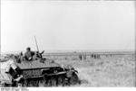 German crew of a Sdkfz. 251 halftrack vehicle watching soldiers in the field, southern Russia, Aug 1942