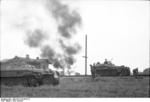 German SdKfz. 250 and SdKfz. 251 halftrack vehicles in a Southern Russian village, 21 Jun 1942; note burning building in background