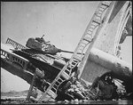 Wreckage of a North Korean T-34/85 medium tank on a bombed out bridge, south of Suwon, Korea, 7 Oct 1950