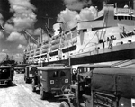 Dodge WC54 ambulances and International Harvester M-5 trucks pick up Okinawa casualties from hospital ship AH-8 USS Mercy with a 400-bed capacity, Guam, Mariana Islands, May 1945