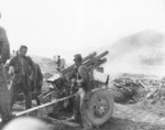 US Army 105mm Howitzer M2A1 crew firing their weapon in Korea, 26 Jul 1950