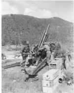 US Army 105mm Howitzer M2A1 crew preparing to fire, Korea, 1950