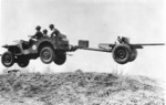 Bantam Jeep, towing a 37 mm Gun M3 piece, jumping over a small hill, New River, North Carolina, United States, 1941