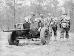 37 mm Gun M3 piece being manhandled into position, Fort Benning, Georgia, United States, Apr 1942