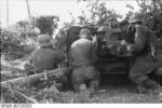Camouflaged German 7.5 cm PaK 40 anti-tank gun position, France, 21 Jun 1944