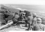 German crew of a 7.5 cm PaK 40 anti-tank gun on a hill above a road, Romania, 1944