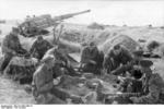 German 8.8 cm FlaK gun crew having a meal in the field, France, summer 1944