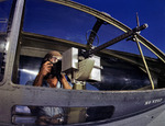 US Navy ordnanceman Jesse Rhodes Waller posing with a M1919 Browning machine gun next to a PBY Catalina aircraft, Naval Air Station, Corpus Christi, Texas, United States, Aug 1942, photo 3 of 3