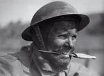 Member of British 3 Commando Brigade in training at Achnacarry, Scotland, United Kingdom, circa 1942-1945; note second pattern F-S dagger between teeth