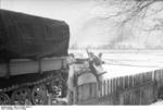 German troops and artillery tractor in wintry terrain, early 1944, photo 1 of 2; note MP 40 submachine gun