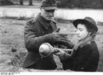 A German Volkssturm soldier teaching a woman how to operate the Panzerfaust weapon, Germany, Mar 1945