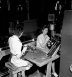 Two female workers assembling PIAT anti-tank launher parts, Orilla, Ontario, Canada, Jun 1944