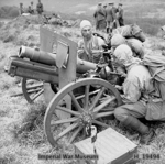 Men of 451st Battery, 1st Mountain Artillery Regiment, Royal Artillery exercising with 3.7-inch howitzers in Trawsfynydd, Wales, United Kingdom, 8 May 1942; note weather gear