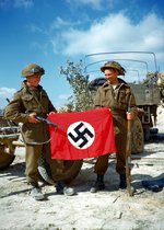 Canadian troops posing with a captured German flag, near Hautmesnil, France, 10 Aug 1944; note Sten gun and Lee-Enfield rifle