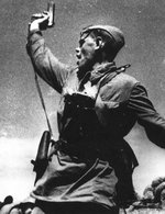 Soviet lieutenant (possibly A. G. Yeremenko of 220th Rifle Regiment of Soviet 4th Rifle Division) waving a TT-33 pistol, Voroshilovgrad region, Ukraine, 12 Jul 1942