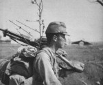 Japanese Army soldier carrying a Type 11 machine gun, date unknown