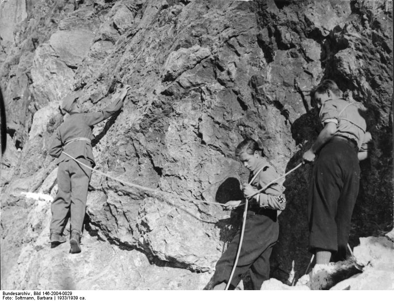 Hitler Youth members rock climing, Germany, 1930s