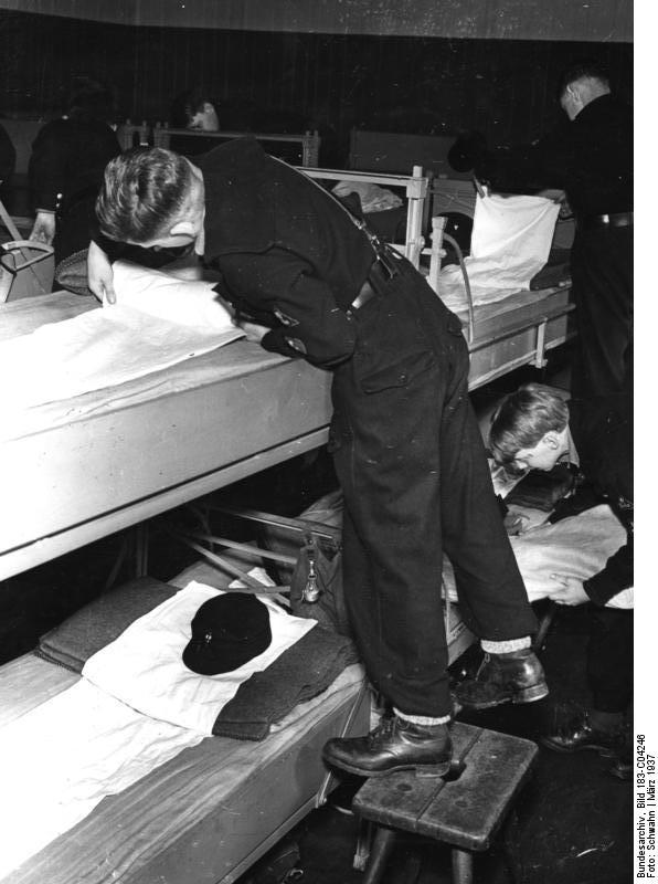 Hitler Youth members making their beds, Brieselang, Germany, Mar 1937