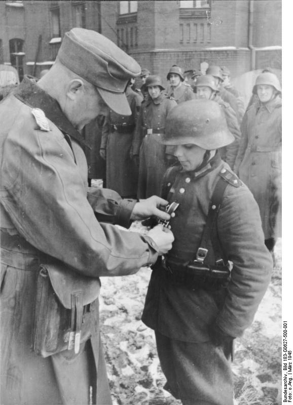 Hitler Youth member Willi Hübner being awarded the Iron Cross 2nd Class medal for bravery in combat, East Prussia, Germany, 9 Mar 1945