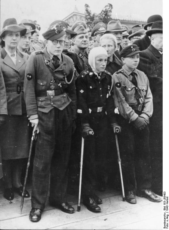 Injured Hitler Youth anti-aircraft battery crewmen being decorated for bravery, fall 1943