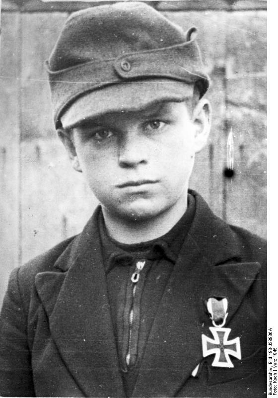 12-year-old Hitler Youth member Alfred Zech from Goldenau, Upper Silesia, Germany posing with his Iron Cross 2nd Class medal, Mar 1945