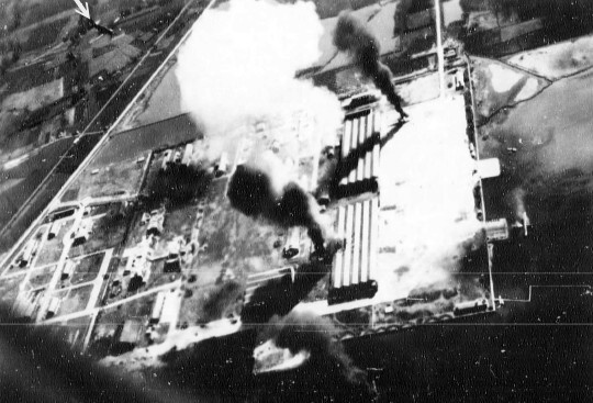 Seaplane hangars under US Navy carrier aircraft attack, Toko Bay (now Dapeng Bay), southern Taiwan, 12 Oct 1944, photo 1 of 7