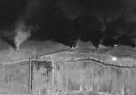 Seaplane hangars under US Navy carrier aircraft attack, Toko Bay (now Dapeng Bay), southern Taiwan, 12 Oct 1944, photo 7 of 7