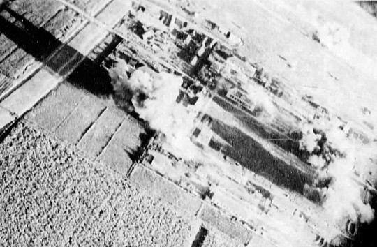 Carrier aircraft of Task Force 38 attacking the Japanese Army airfield at Takao (now Kaohsiung), Taiwan, 12 Oct 1944, photo 4 of 4; US intelligence referred to this field as 'Reigaryo Airfield'